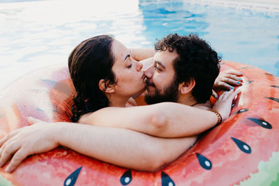 Young couple kissing in water