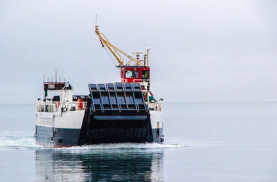 Ship sailing in sea against clear sky