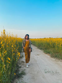 Full length of woman walking on land against clear sky