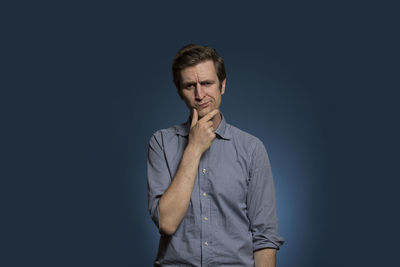 Portrait of mid adult man against black background