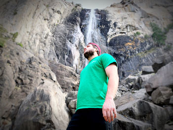 Full length of man climbing rock