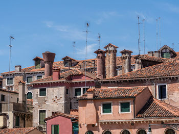 Low angle view of buildings in town against sky