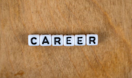 Close-up of information sign on wooden table