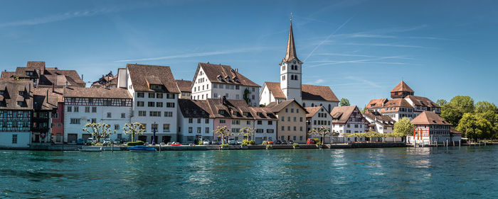 River amidst buildings against sky in city