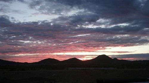 Scenic view of mountains against cloudy sky