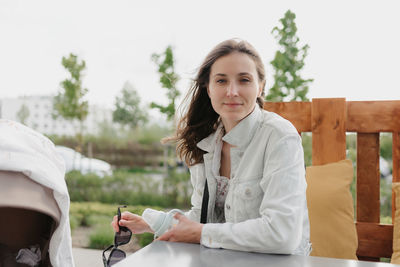 Portrait of young woman using mobile phone