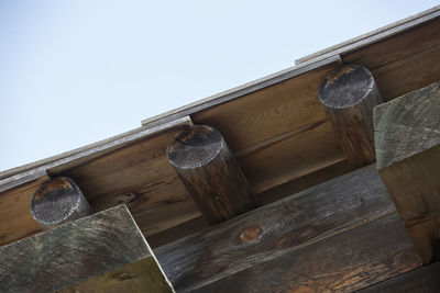 Low angle view of old roof and building against sky