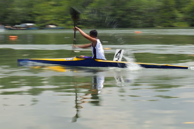 Full length of man sitting in river