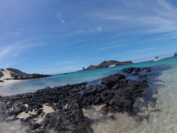 Scenic view of beach against blue sky