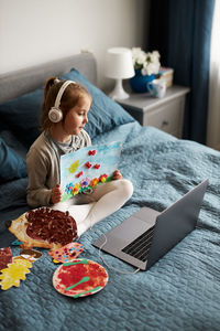 Girl using laptop while sitting at home