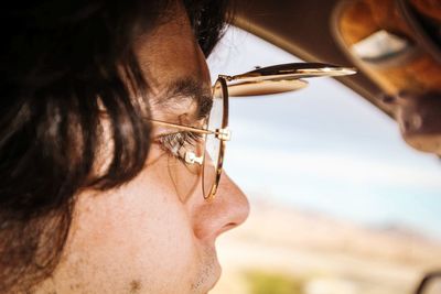 Close-up of woman wearing sunglasses in car