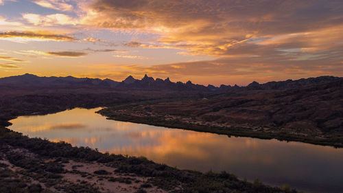 Scenic view of lake against sky during sunset