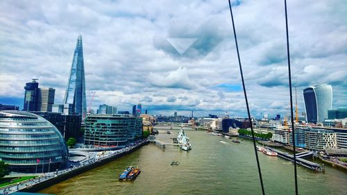 View of cityscape against cloudy sky