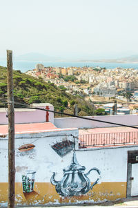 View of townscape by sea against clear sky