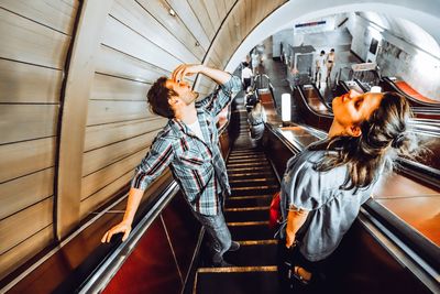 Friends standing on escalator