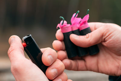 Close-up of hand holding pink bottle