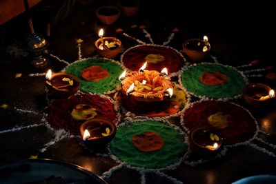 High angle view of lit candles