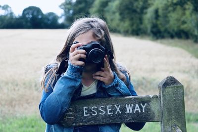 Portrait of woman photographing