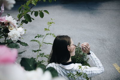 High angle view of young woman by plants at road