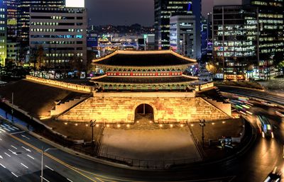 High angle view of illuminated buildings in city at night