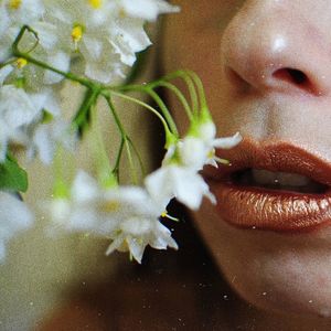 Cropped image of woman with flower