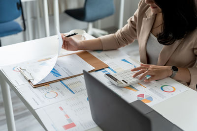 Midsection of business people working at office