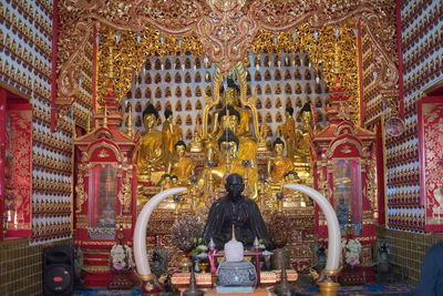 Rear view of buddha statue in temple