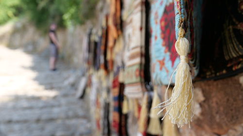 Close-up of clothes hanging on wall in old building