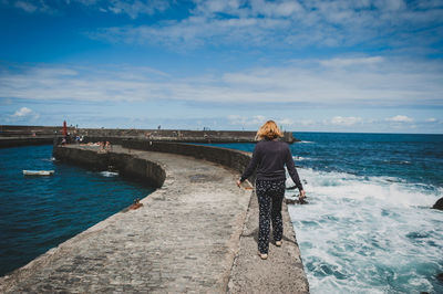 Man standing on pier