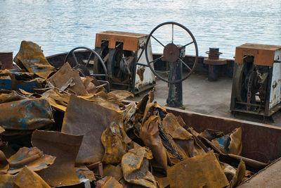 High angle view of abandoned garbage on field by sea