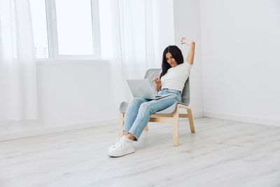 Side view of woman exercising on floor at home