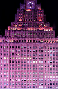 Low angle view of illuminated building against sky at night