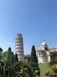 Low angle view of buildings against clear blue sky