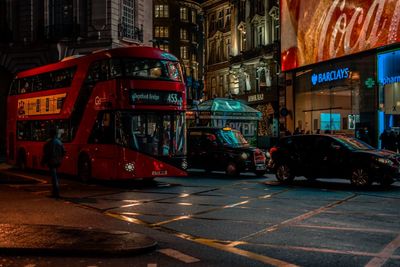 View of city street and buildings at night