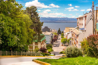 Scenic view of lake by buildings against sky