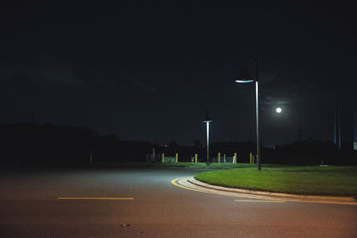 Empty road against sky at night