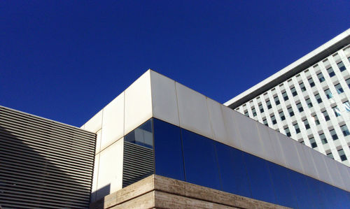 Low angle view of skyscraper against clear blue sky