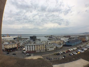 View of cityscape against cloudy sky