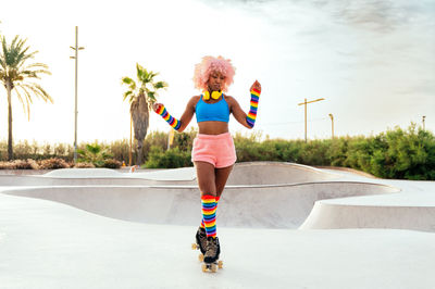 Full length of young woman standing on road