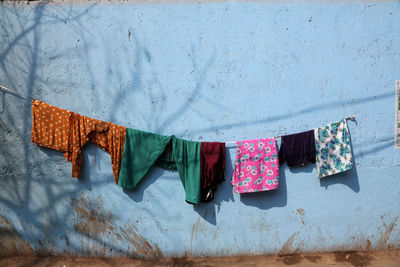 Clothes drying on clothesline against wall