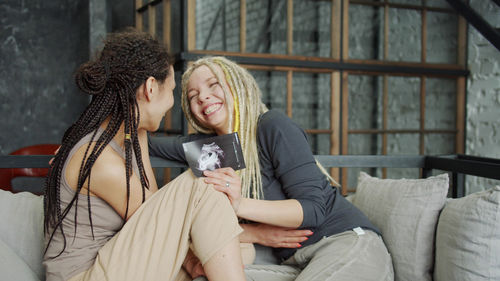 Young woman smiling while sitting outdoors