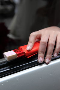 Close-up of person using mobile phone on table