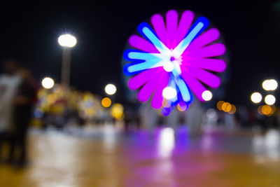 Defocused image of illuminated street lights at night