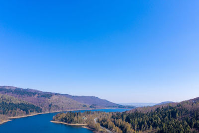 Scenic view of mountains against clear blue sky