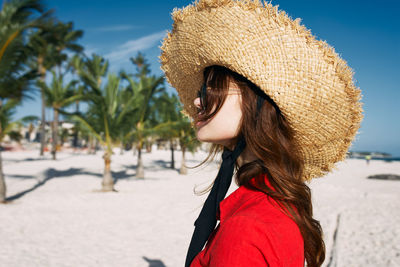 Portrait of young woman wearing hat outdoors