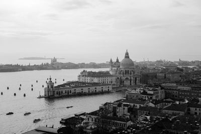 Santa maria della salute by grand canal against sky in city