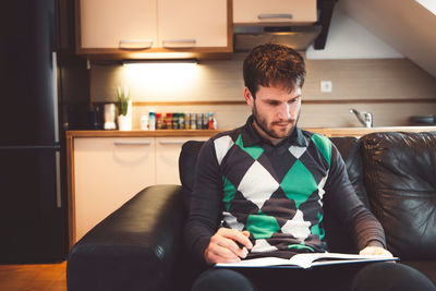 Young man using laptop at home