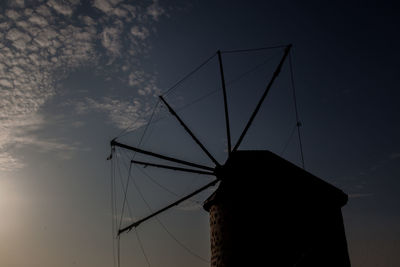 Low angle view of silhouette sailboat against sky at sunset