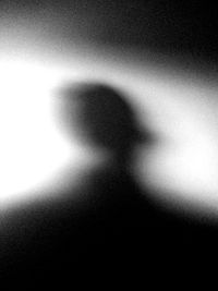 Close-up of shadow of woman over white background