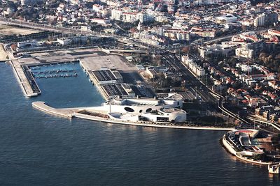 High angle view of buildings and sea in city